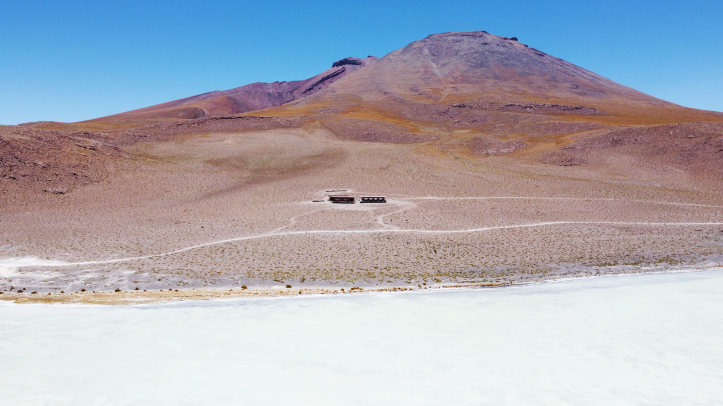 Lodge nestled in a remote desert landscape, overlooking a salt flat