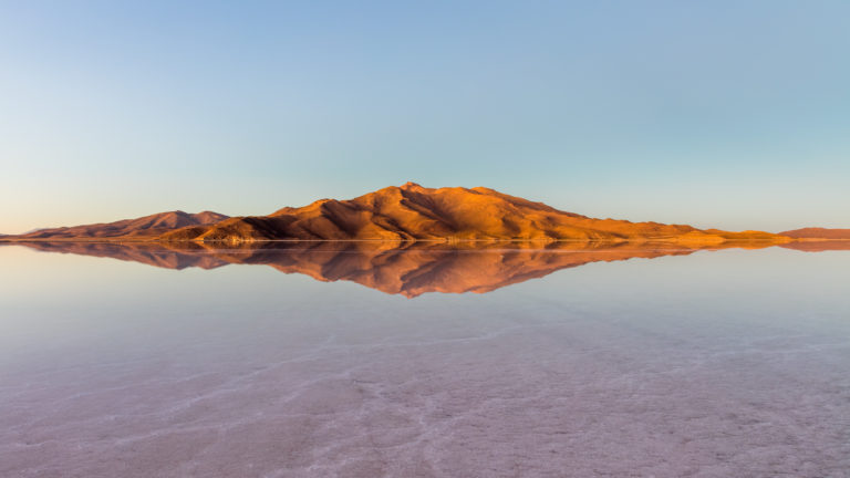 Stunning reflection of mountains in the Salar de Uyuni salt flat