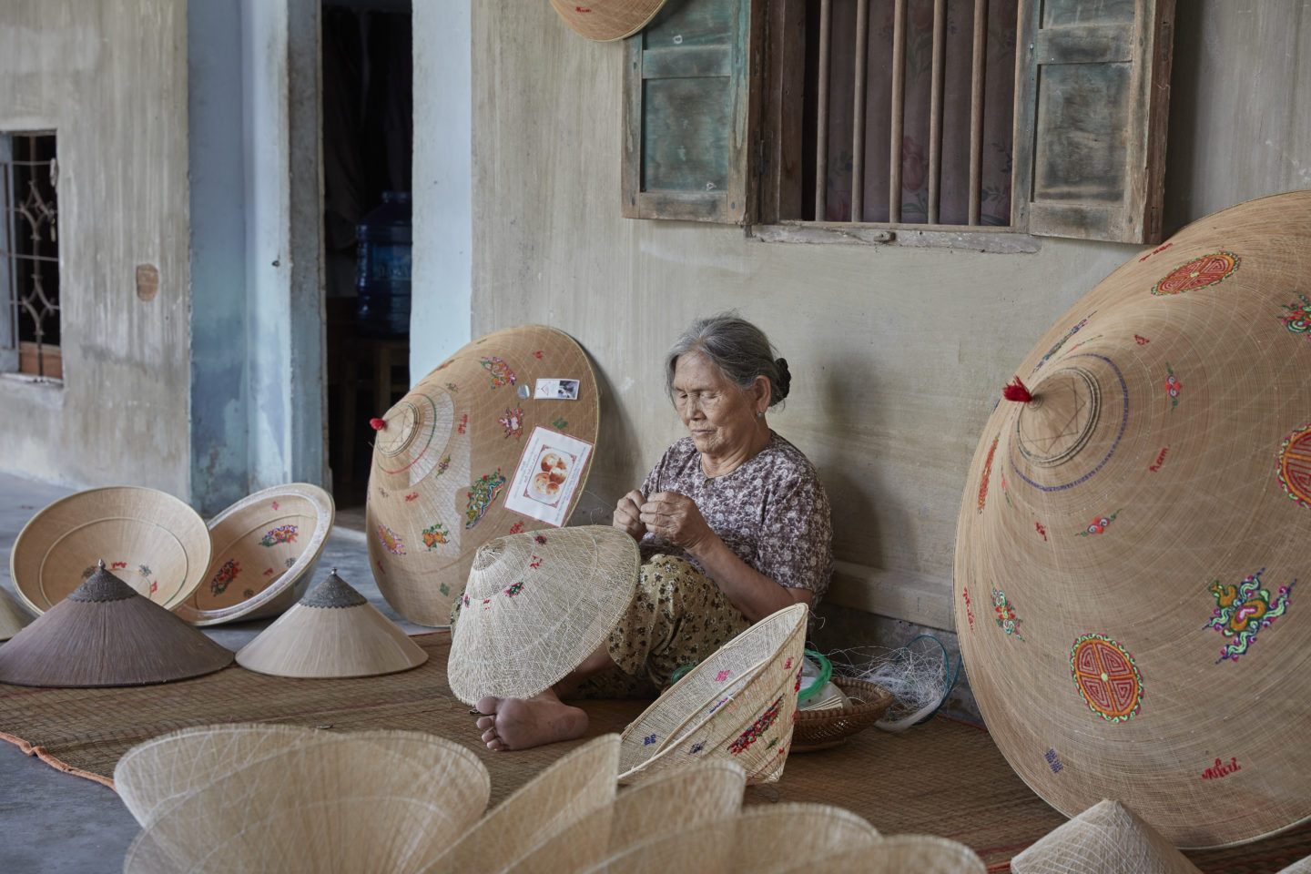 Woman engaged in the art of hat crafting