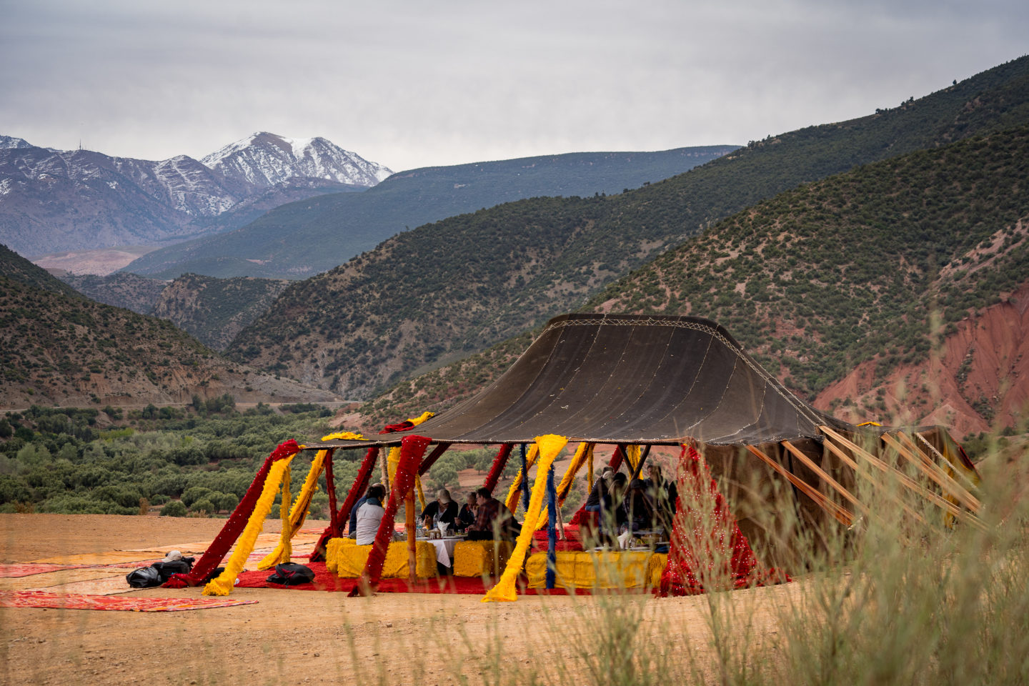 Traditional Berber tent in the Atlas Mountains, with people gathered inside