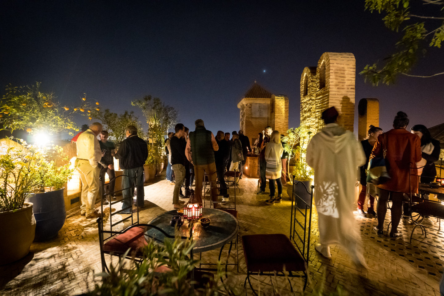 A lively gathering of people enjoying a night on the patio at Dar Yacut