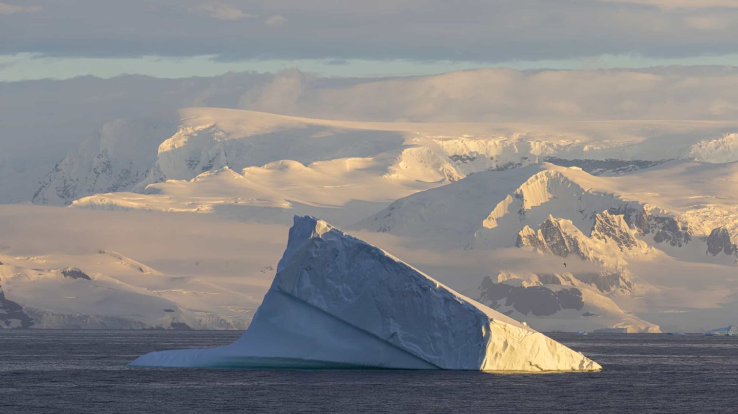 Massive iceberg drifts in the ocean, a breathtaking scenery of Antarctica