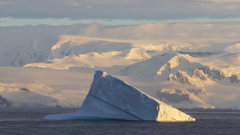 Massive iceberg drifts in the ocean, a breathtaking scenery of Antarctica