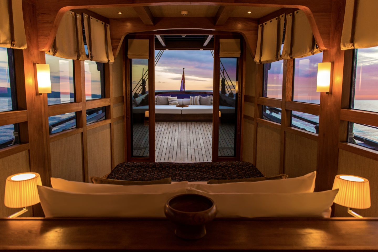 Tranquil bedroom with a bed overlooking the ocean, on the luxury Amandira yacht