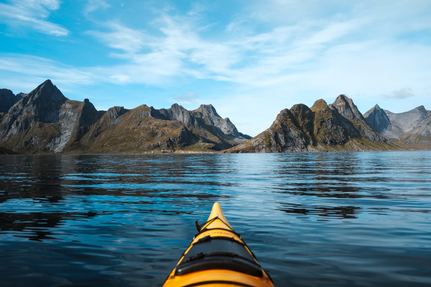 Panoramic Lofoten Islands view from a yellow kayak, amidst rugged fjords