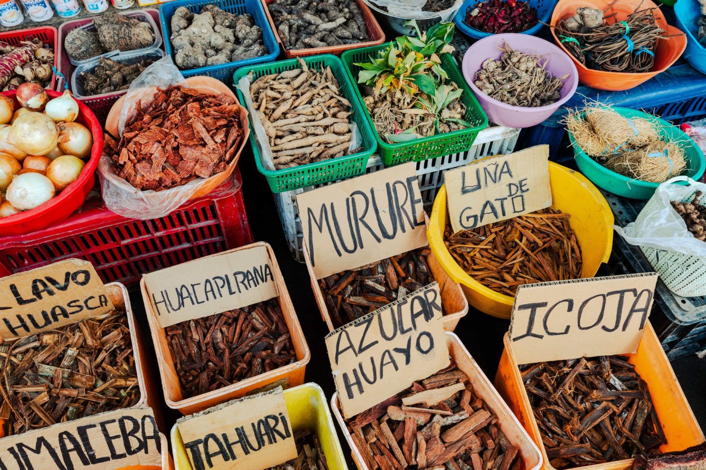 Colorful assortment of spices and herbs in baskets at a Peruvian market