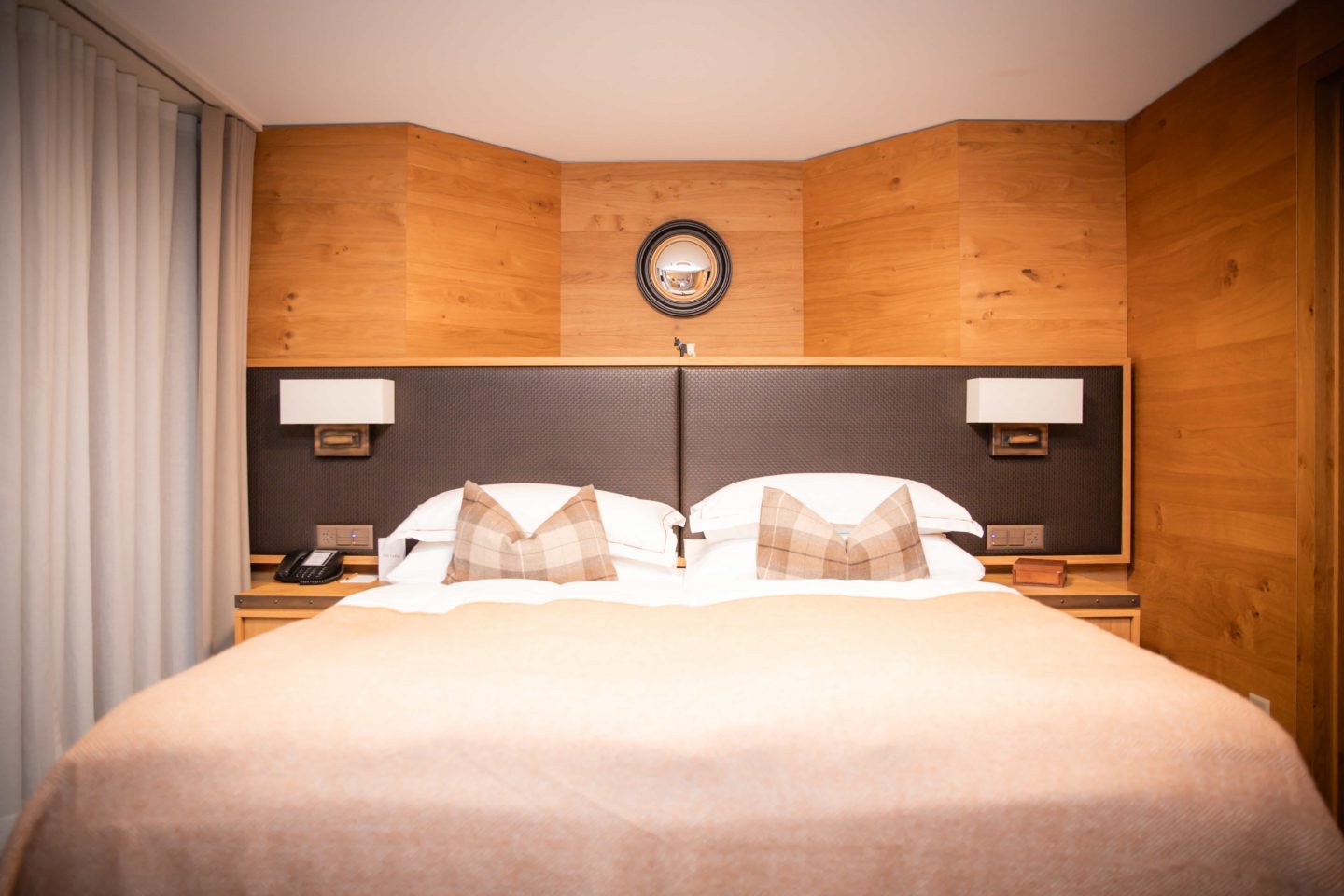 Cozy bed set in The Capra lodge, warm and inviting atmosphere