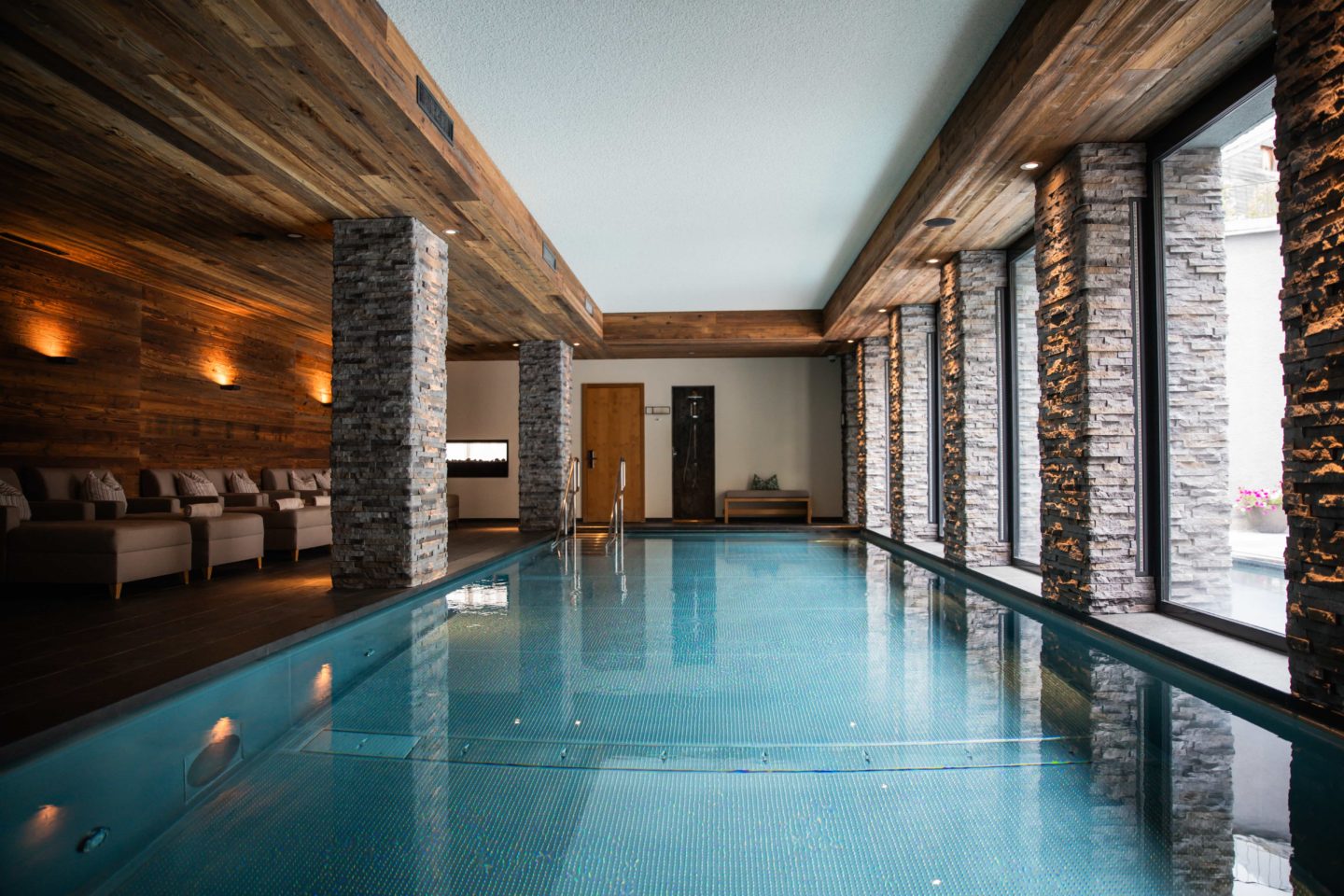 Indoor pool area with sparkling water and comfortable seating